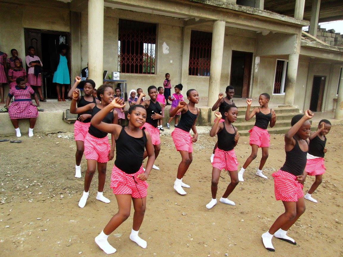 Children in black and pink performing contemporary dance